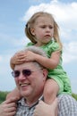 Worried girl on grandpas shoulders