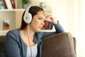 Worried girl listening to music at home