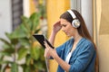 Worried girl listening and watching tablet content