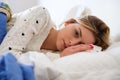 Worried girl lying on the bed having to wake up Royalty Free Stock Photo