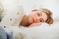 Worried girl lying on the bed in the morning light Royalty Free Stock Photo