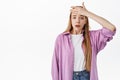 Worried girl student holding hand on forehead, slap face and look alarmed and nervous, feeling anxious as forgot