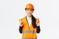 Worried hopeful asian female architect feeling nervous as waiting for inspection results at construction area, wearing