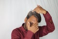 Worried Indian man showing his white hair and hair loss problem at a young age Royalty Free Stock Photo