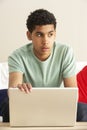 Worried Looking Boy Using Laptop Royalty Free Stock Photo