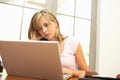 Worried Looking Teenage Girl Using Laptop At Home Royalty Free Stock Photo