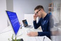 Worried Man At Computer With System Failure On The Screen