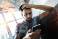 Worried man discovering unpleasant news when reading messages Royalty Free Stock Photo