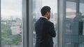 Worried man finish call standing near office window closeup. Manager thinking. Royalty Free Stock Photo
