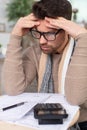 worried man looking at bills in kitchen Royalty Free Stock Photo