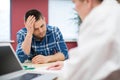 Worried Man Meeting With Female Doctor In Surgery