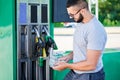 Worried man shocked how much gasoline costs. Royalty Free Stock Photo