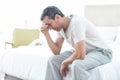 Worried man sitting on bed Royalty Free Stock Photo