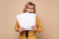 Worried mature business woman reading documents. Upset woman frustrating with papers.