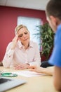 Worried Mature Woman Meeting With Doctor In Surgery Royalty Free Stock Photo