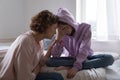 Worried mom comforting depressed teen daughter crying at home Royalty Free Stock Photo