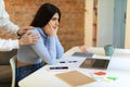 Worried mother calming her sad spanish teenage daughter, lady sitting at desk with laptop and studying online from home Royalty Free Stock Photo