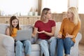 Worried mother complaining grandmother about daughter using laptop, home interior Royalty Free Stock Photo