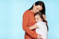 Worried mother embracing and consoling her young daughter. Family relationships concept.