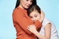 Worried mother embracing and consoling her young daughter. Family relationships concept.