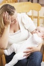 Worried Mother Holding Baby In Nursery