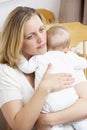 Worried Mother Holding Baby In Nursery