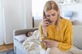 Worried mother taking temperature of her little son who is lying in bed with fever. Young mother checking the temperature of her