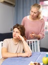 Worried mother talking to upset teenage son at home Royalty Free Stock Photo