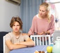 Worried mother talking to upset teenage son at home Royalty Free Stock Photo