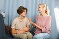 Worried mother talking to upset teenage son at home Royalty Free Stock Photo