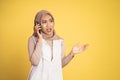 worried muslim woman in hijab making a call using a cell phone Royalty Free Stock Photo