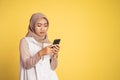 worried muslim woman in hijab using a cell phone