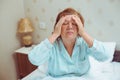 Worried old woman has headache at home. Royalty Free Stock Photo