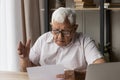 Worried older man read bad news in paper letter Royalty Free Stock Photo