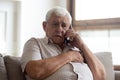 Worried older unhealthy man making emergency 911 call.