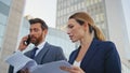 Worried partners reading report walking street close up. Two business people Royalty Free Stock Photo