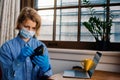 Worried person with virus protection mask and gloves holding wallet