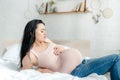 Worried pregnant girl having pain and touching belly Royalty Free Stock Photo