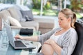 Worried pregnant woman calculating her bills