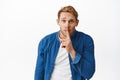 Worried redhead man asking to keep quiet, have secret, shushing with finger pressed to lips, make shhh hush sign with Royalty Free Stock Photo