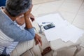 Worried senior couple checking bills in living room Royalty Free Stock Photo