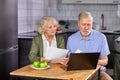 worried senior couple checking finances at home using laptop Royalty Free Stock Photo