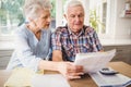 Worried senior couple checking their bills Royalty Free Stock Photo