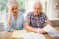 Worried senior couple checking their bills Royalty Free Stock Photo