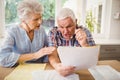 Worried senior couple checking their bills Royalty Free Stock Photo