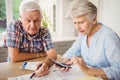 Worried senior couple checking their bills Royalty Free Stock Photo