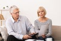 Worried Senior Couple Checking Their Bills At Home Royalty Free Stock Photo
