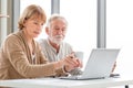 Worried senior couple checking their bills, retired elderly old family reading documents Royalty Free Stock Photo