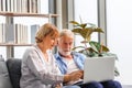 Worried senior couple checking their bills and work on netbook read document information at home, retired elderly old family Royalty Free Stock Photo