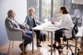 Worried Senior Couple Having Consultation With Female Doctor In Hospital Office Royalty Free Stock Photo